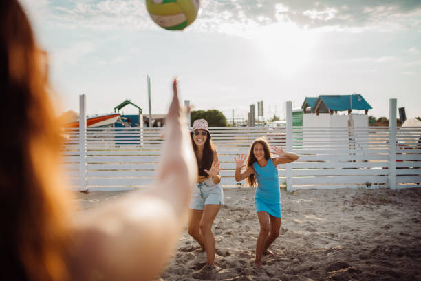 istock family playing with a ball on the beach 1661595640
