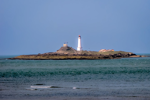 Evening image of a light house on sea shore with nice blue sky background in Dwarka, Gujrat,India.