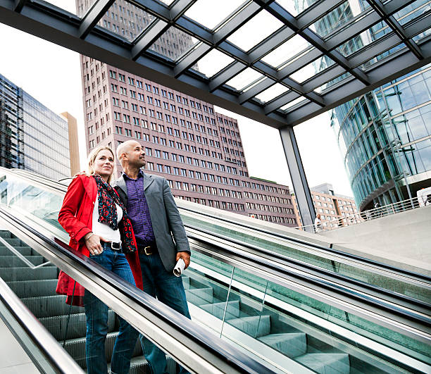 istock Couple Descending on Urban Escalator 166159872