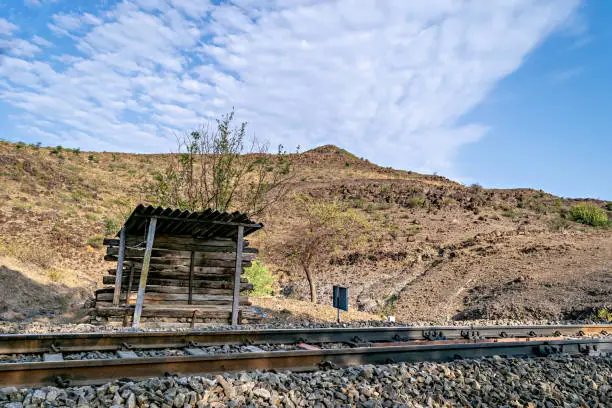 Photo of make-shift Gang-man's hut made of railway items for shelter during patrolling and guarding railway tracks with clear blue sky background