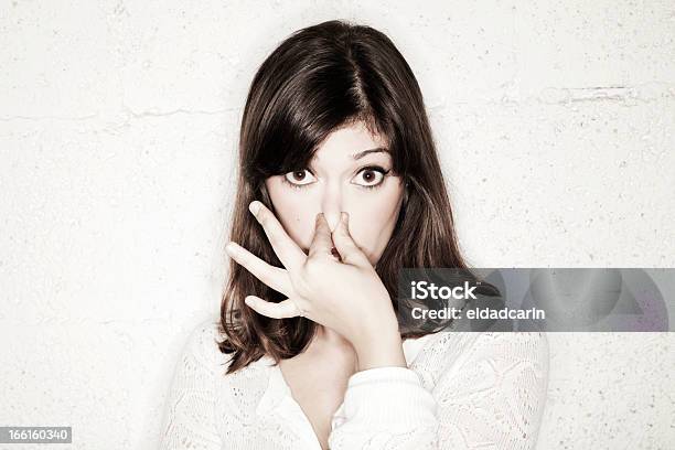 Young Wideeyed Woman Pinching Her Nose Stock Photo - Download Image Now - High Contrast, Human Face, Portrait