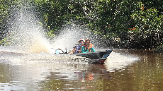 Residents of Kapuas City, Central Kalimantan Province cross the river using motorized boats or in local language called kelotok.