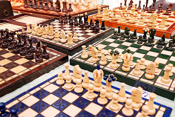 Chess Boards For Sale at Mauerpark Sunday Flea Market A large amount of homemade chess boards displayed for sale on a table at the Mauerpark sunday flea market. mauer park stock pictures, royalty-free photos & images