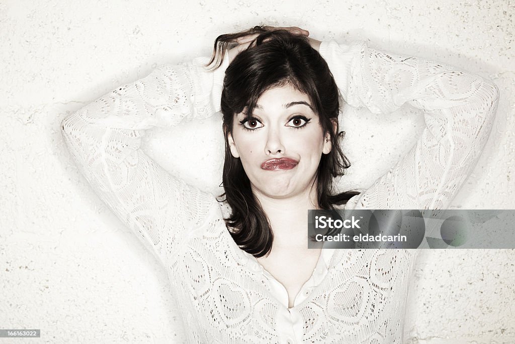 Clueless and Confused Portrait of a beautiful young woman holding her hands on her head and looking at the camera with a very cute confused & clueless expression, looking very helpless and naive. Care to help a girl in need? 20-24 Years Stock Photo