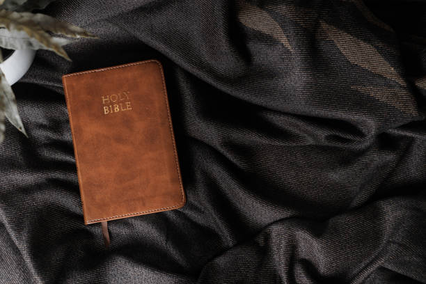 istock bible on a wooden table, there is an environment of shadows. copyspace, flat lay 1661630766