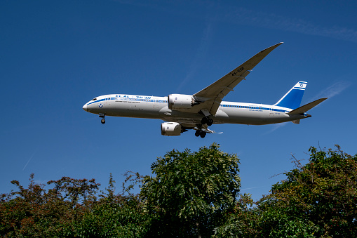 An El Al Boeing 787 Dreamliner jet during final approach to landing at Heathrow Airport in London on a beautiful summer day.