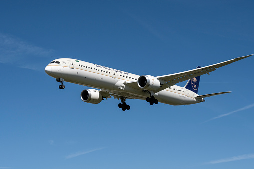 Saudi Arabian Airlines, Boeing 787-10 Dreamliner during final approach to landing at Heathrow Airport in London on a beautiful summer day.