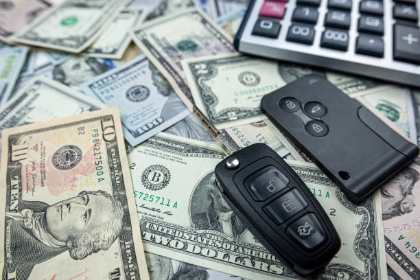 istock real car keys with calculatorover dollars cash background 1661658104