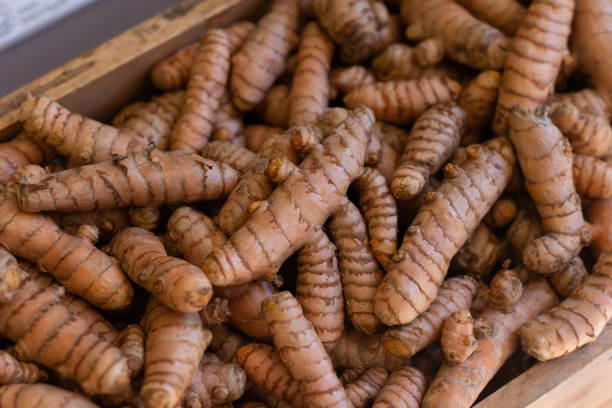 istock Fresh tumeric root in wooden box at market store 1661676423
