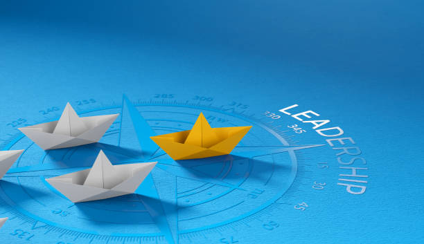 istock Leadership concept, yellow leader boat leading whites on compass 1661678523