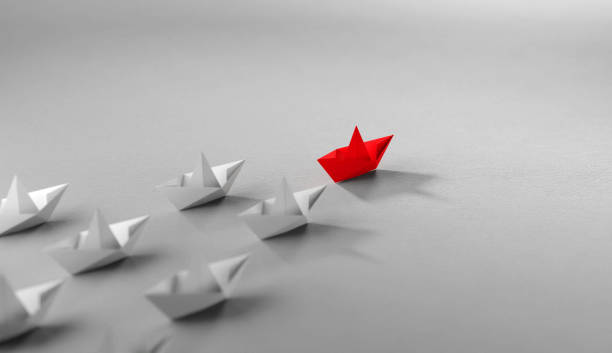 istock Leadership concept, Red leader boat leading whites 1661678536