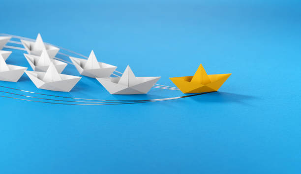 istock Leadership concept, yellow leader boat leading whites 1661678540
