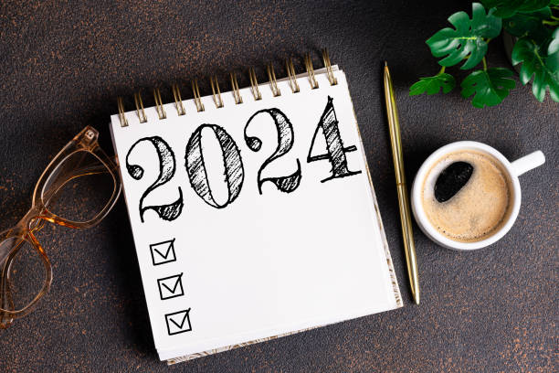 istock New year resolutions 2024 on desk. 2024 goals list with notebook, coffee cup, plant on table. Resolutions, plan, goals, action, checklist, idea concept. New Year 2024 resolutions 1661678543