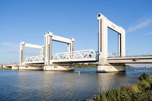 Rotterdam,  Netherlands - July 5, 2019: Botlekbrug (Botlek bridge), a lifting bridge for road and rail traffic over the Oude Maas in the Rotterdam port area