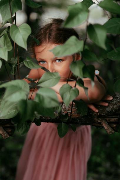 istock young girl posing with her hand near some branches and plants 1661692964