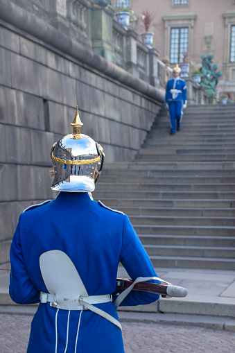 Stockholm, Sweden - July 28, 2023: Sweden Royal Guard in blue uniform protecting Royal Palace in Stockholm.