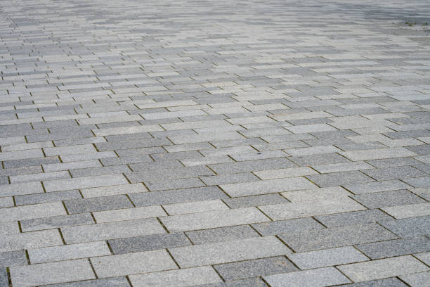 istock gray paved road from concrete pavers 1661733638