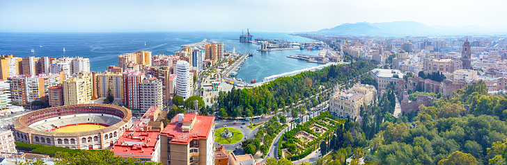 Malaga cityscape with Bullring of La Malagueta and harbor, Spain