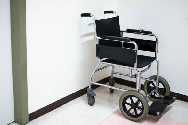 istock Black Wheelchair on hospital floor with white background 1661807404