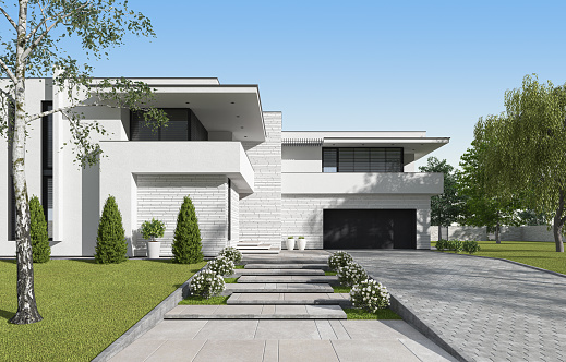 Modern two floors white villa with white stone facade. Luxury exterior concept with beautiful garden. Summer time.