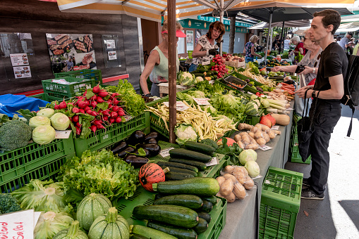 Graz, Austria - August 26, 2023: Stall with vegetables greens and fruit at the farmer's market in Kaiser-Josef-Platz