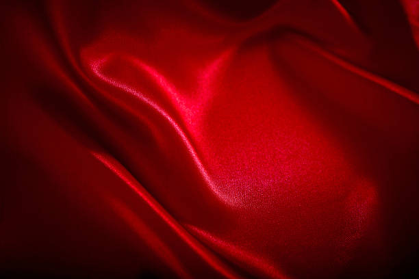 Red Satin Background Red satin background. Perfect for valentines day or Christmas. silk stock pictures, royalty-free photos & images