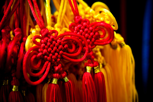 Chinese lucky knots, hanging in Shanghai China, souvenir shop. Charm for good luck, peace, health and prosperity.