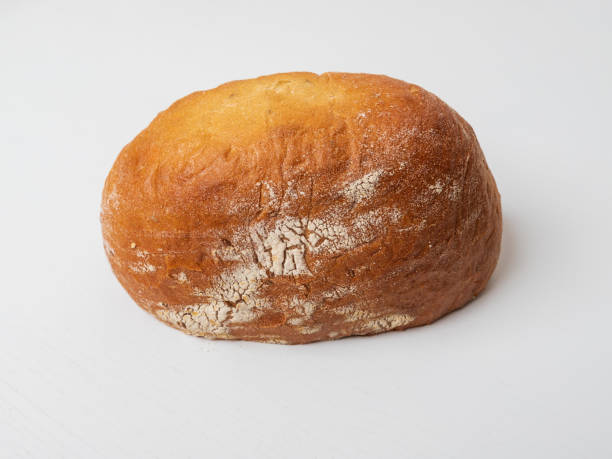 istock A slice of fresh round loaf of bread on a white table. 1661876019
