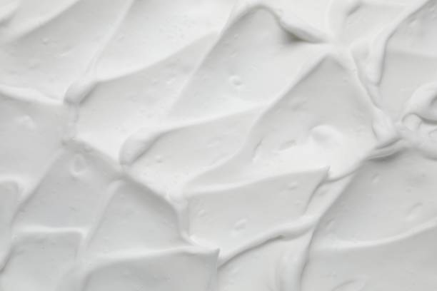 istock Texture of white shaving foam as background, top view 1661902368