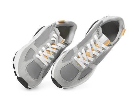 Pair of stylish grey sneakers isolated on white