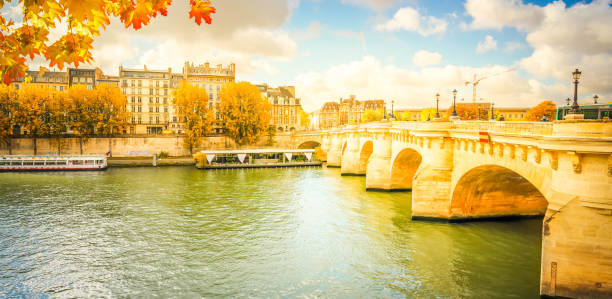 Pont Neuf and river Seine waters, blue fall sky with clouds, Paris, France