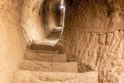 Stone tunnel and staircase drilled in the rock in Vardzia cave monastery complex in Georgia, inside view of underground medieval city.