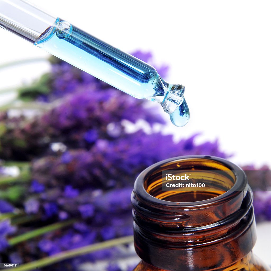lavender essence a pile of lavender flowers and a dropper bottle with lavender essence Alternative Medicine Stock Photo