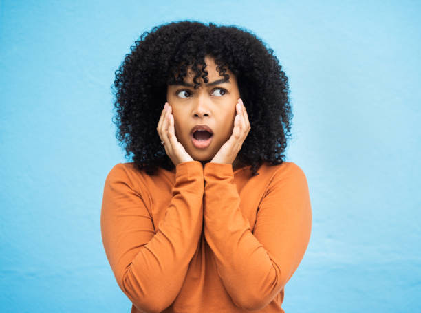 istock Wow, surprise and idea with a black woman in shock standing on a blue background in studio. Omg, confused and thinking with an attractive young female looking shocked or surprised indoor 1661949507