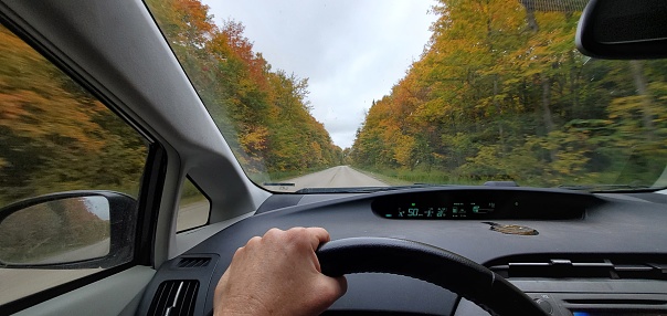 This is a photograph taken on a mobile phone while driving on a rural country road in autumn in the Upper Penninsula of Michigan, USA.