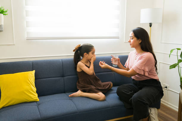 istock Sick kid rejecting syrup medicine from her mother 1661963380