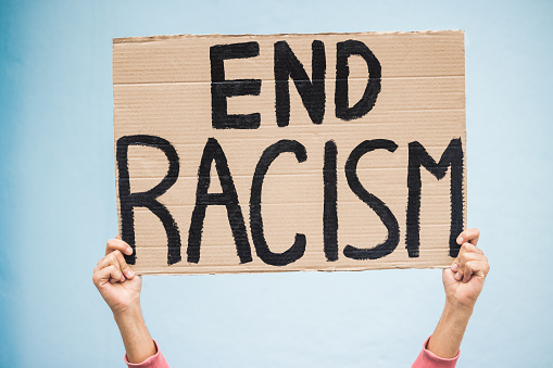 Group of people holding banner signs during a social protest - Empty signs for copy space. Hispanic and caucasian ethnicities.