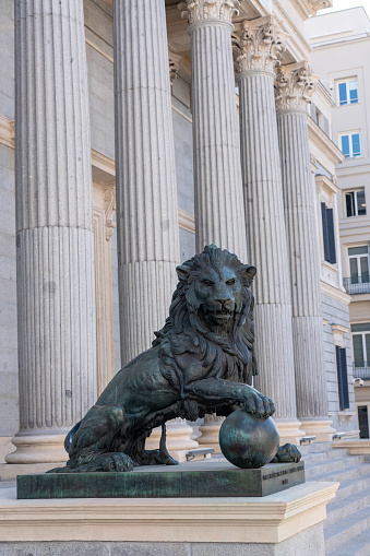 Bronze lion at the entrance to the Congress of Deputies. Madrid. Spain. July 27, 2023.