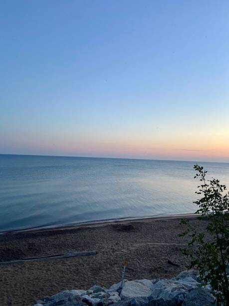 istock Sunrise at the beach with rocks 1661995862