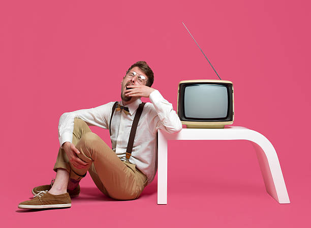 istock Yawning young man sitting next to TV 166200624
