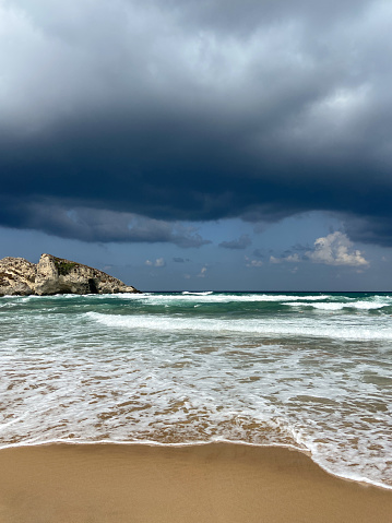 Storm and rain clouds on the beach. Dramatic sky, sea, and beach background