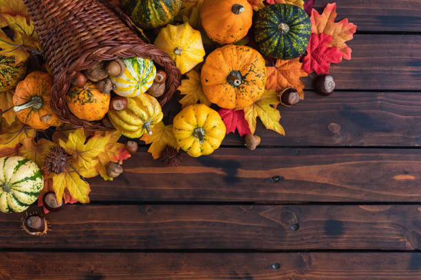 istock Decorated or Autumn Thanksgiving Cornucopia on a wooden background 1662029278