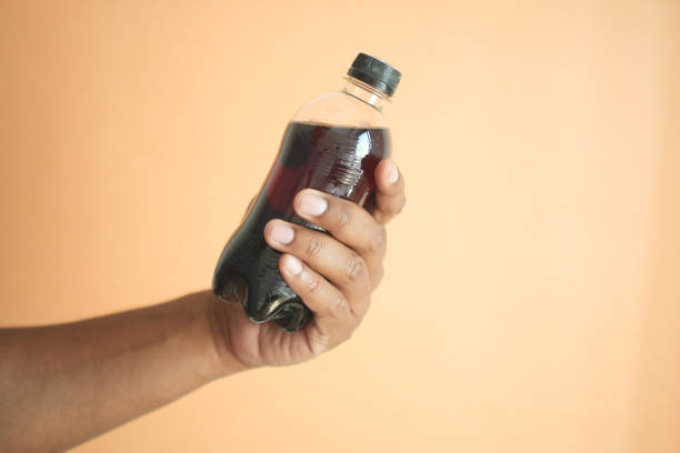 istock men holding a plastic bottles of soft drink against orange background 1662030880