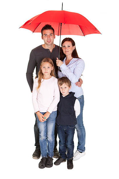 istock Happy young family standing under one umbrella 166204006