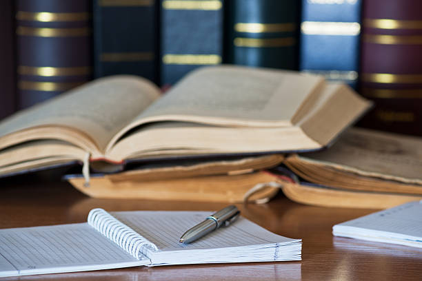 istock Metallic pen, spiral notebook and books on the background 166204125