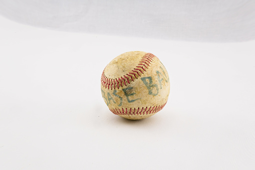 leather baseball with red stitches isolated