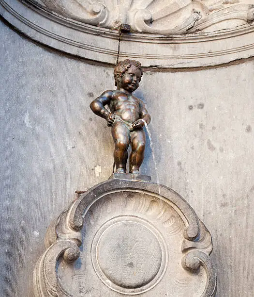 Manneken Pis is a famous Brussels landmark. It is a small bronze fountain sculpture depicting a naked little boy urinating into the fountain's basin
