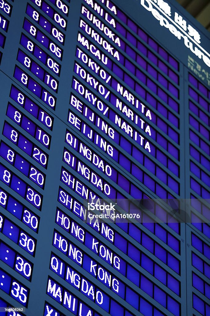 Airport Flight Information Board Flight information board in English in Incheon International Airport (Seoul, South Korea) in the morning. Shallow DOF Airport Stock Photo