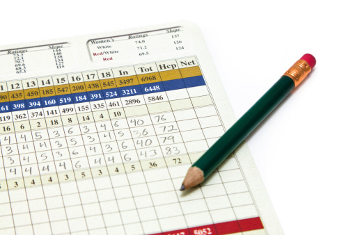 A filled out golf scorecard with a pencil sitting on top of it.