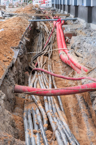 istock underground electric cable infrastructure installation. Construction site with A lot of communication Cables protected in tubes. electric and high-speed Internet Network cables are buried underground on the street 1662102615